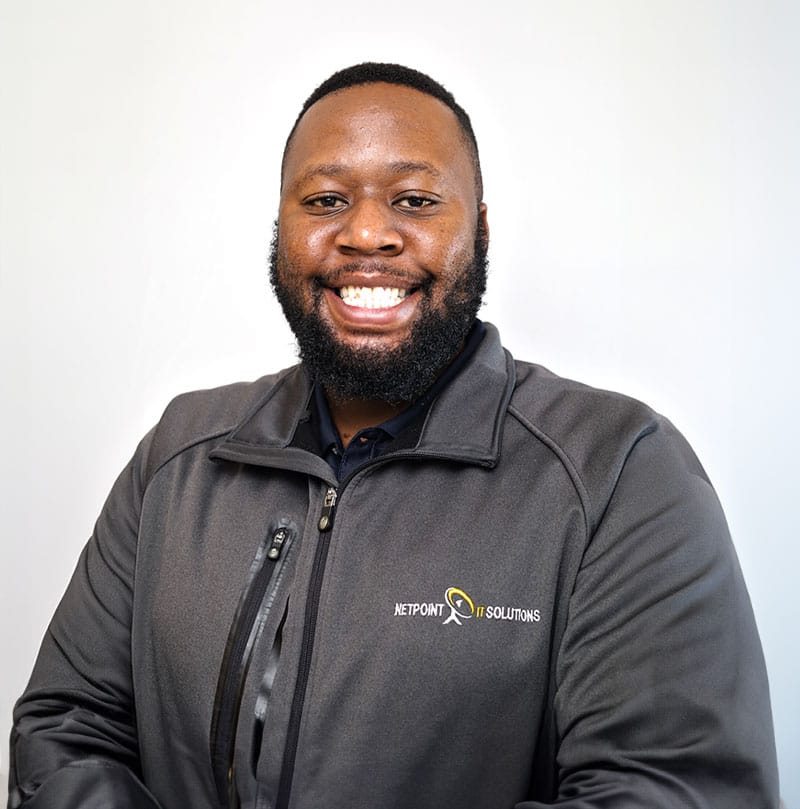 Smiling NetPoint IT Solutions team member wearing branded jacket